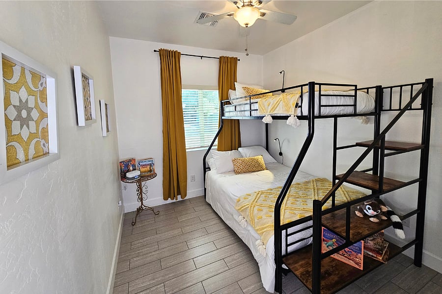 Secondary bedroom has twin over full bunk bed has stairs with a railing for ease and safety for all ages.