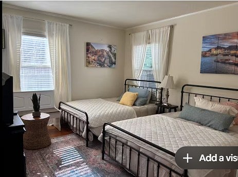Shared bedroom with full sized beds, tv, closet