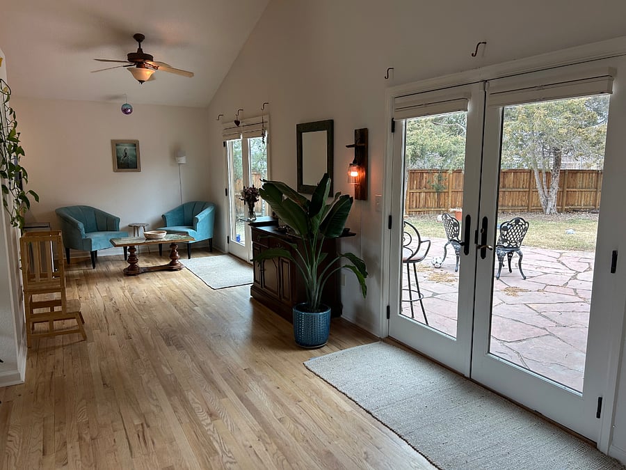 Seating area near kitchen and two sets of french doors to back patio/yard