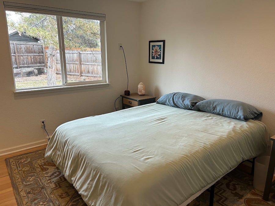 Queen room upstairs with views of private backyard.