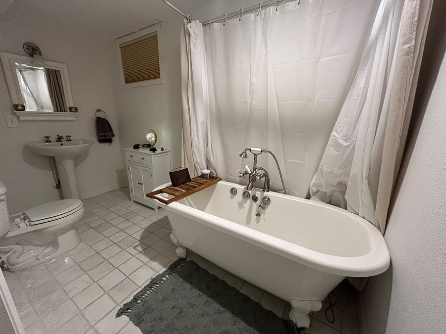 Downstairs full bathroom with huge claw bathtub.