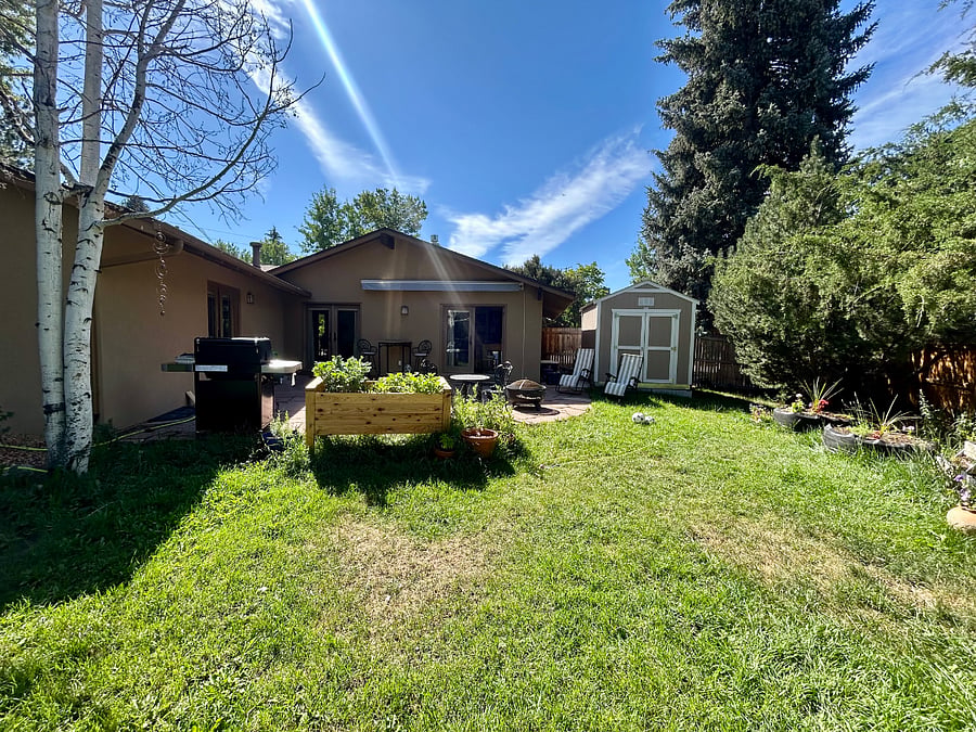 View of house from backyard with the shed.