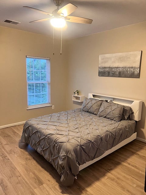 Queen Bed with lights and a remote control.