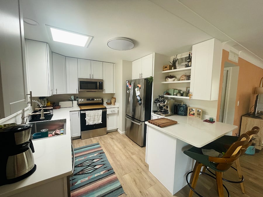 View of kitchen from sliding door that leads to back patio and fenced in yard