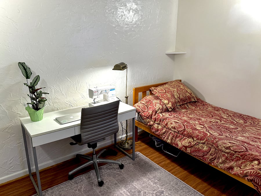 The shared guest room / office now has a futon & TV but we haven't gotten new photos. Laura is a costume maker, she sews here sometimes.