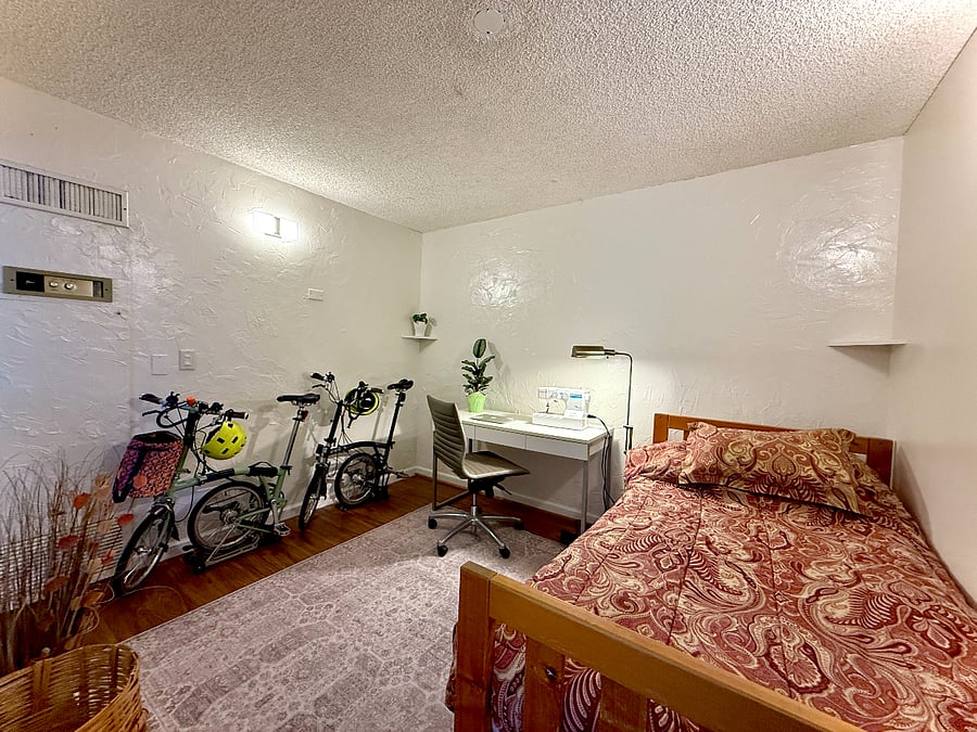 The shared guest room / office now has a futon & TV but we haven't gotten new photos. We store our folding bikes in this room, (and you're welcome to as well).