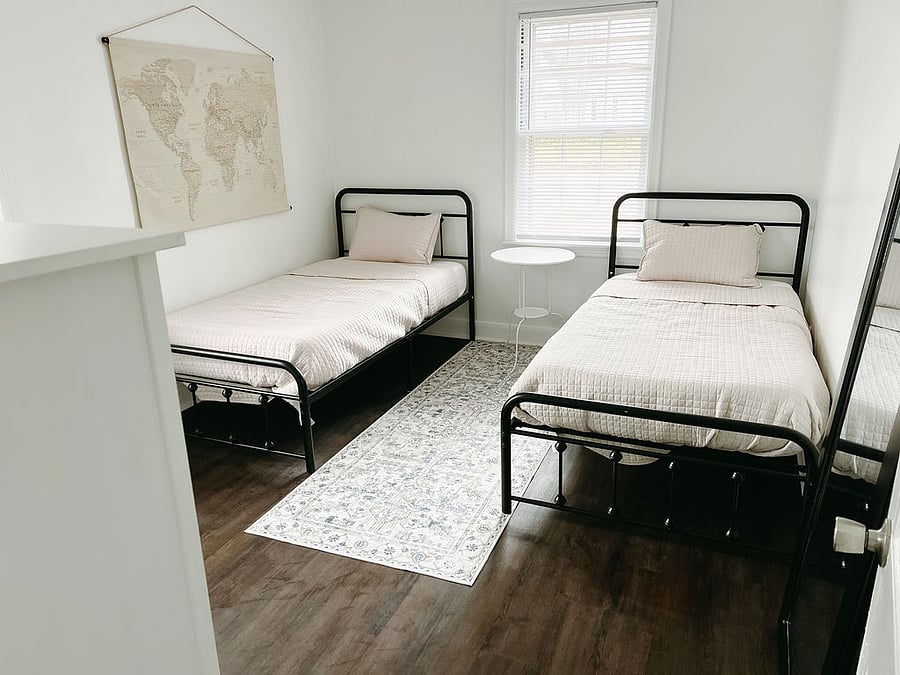 Perfect for families or friends, this room features two twin beds with crisp, clean linens and a welcoming vibe. Stay organized with a roomy dresser and closet, while USB ports ensure everyones devices stay charged. A full-length mirror makes getting ready a breeze.
