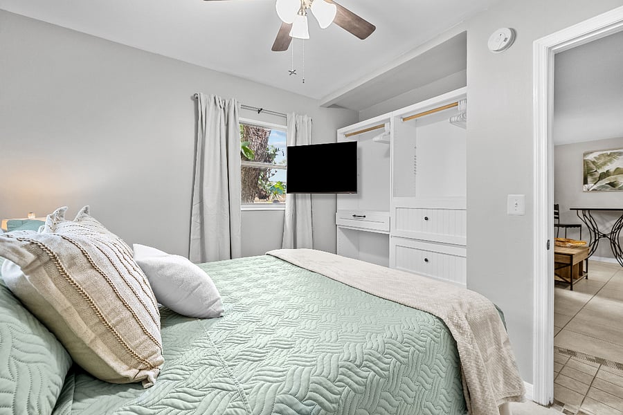 Queen bed with blackout curtains and a smart TV