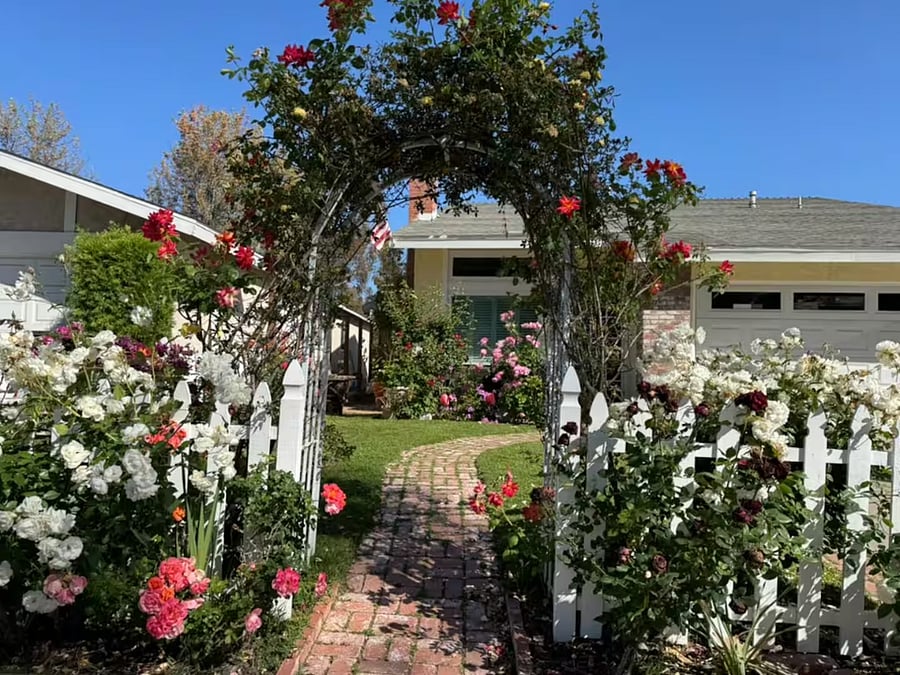 Arrive through a blooming archway of roses and follow a garden path that sets the tone for a peaceful and inviting stay. This storybook entrance welcomes you to your home-away-from-home in sunny Mission Viejo.