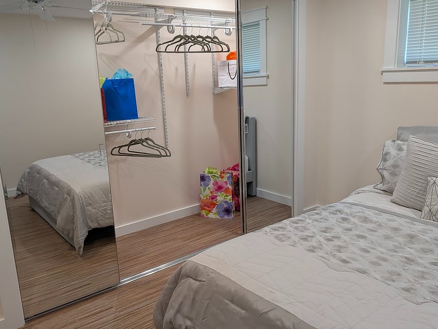 Large mirrored closet with organizers and shelving