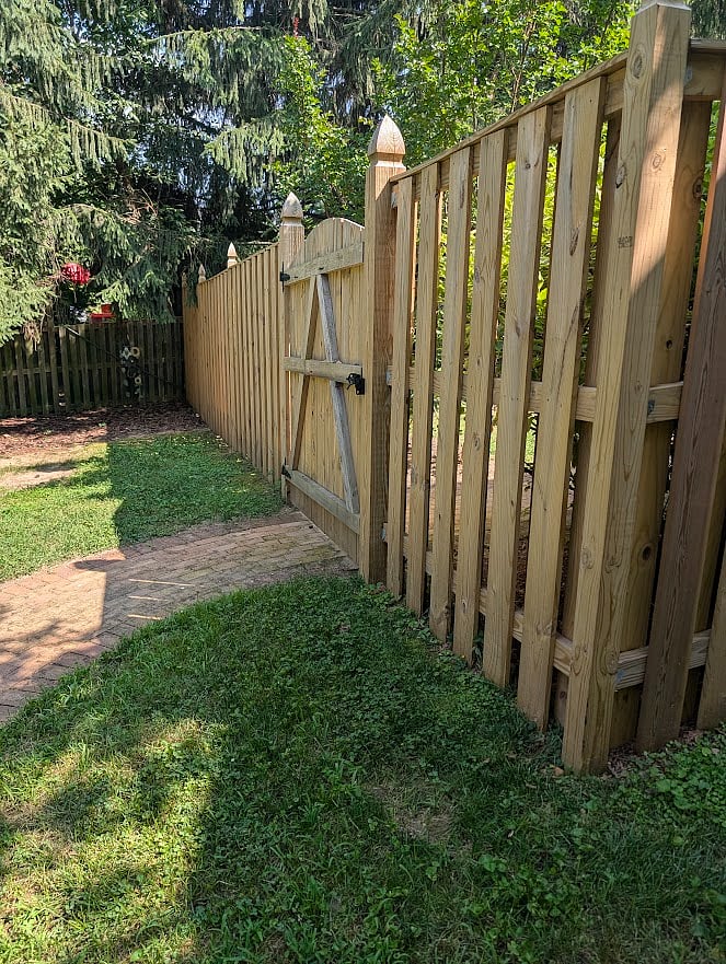 Walk through fenced yard gate to apartment entry