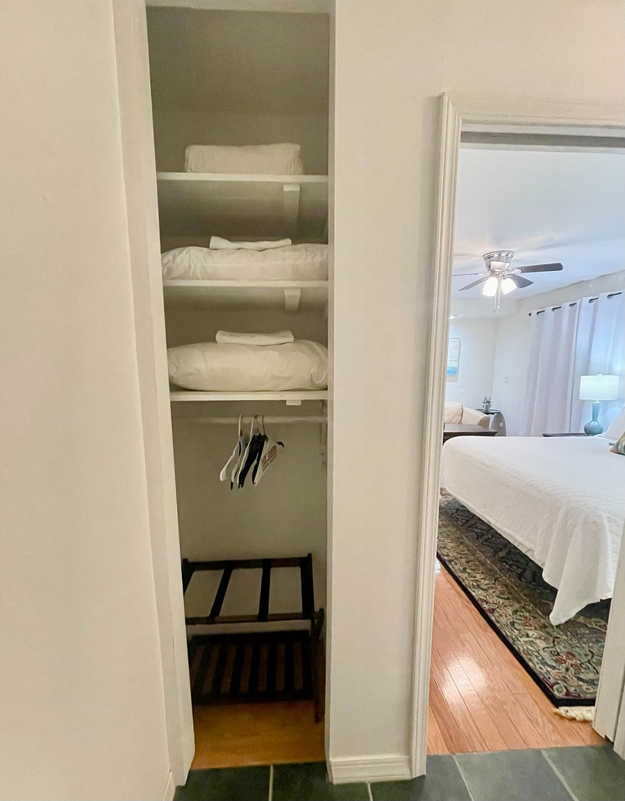 Closet just inside bathroom door for king bedroom