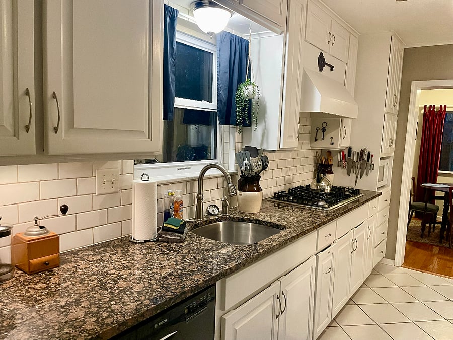 Kitchen is stocked with cooking and dining implements