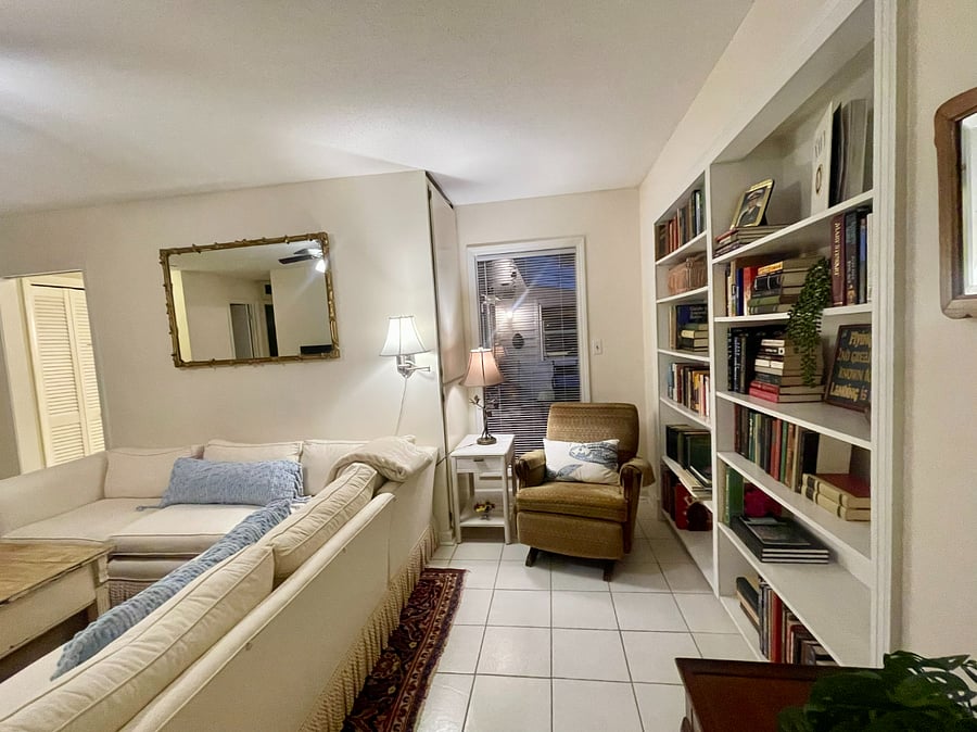 A library of books for guests to enjoy, cozy reading chair