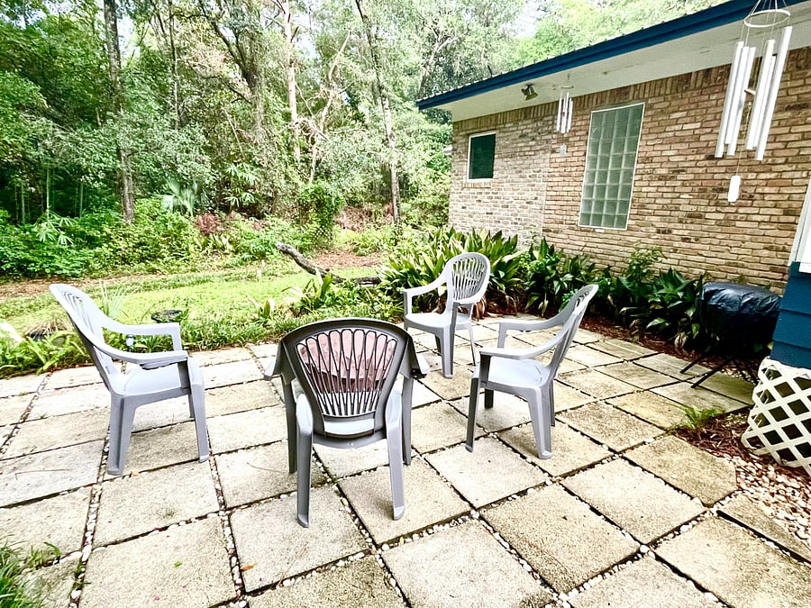 Fire pit, seating and charcoal grill on back patio