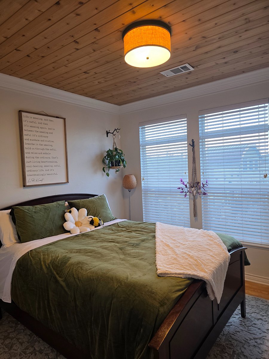 Second bedroom filled with natural light, a queen bed to sink in to and a large closet. Wood ceilings give it a warm Colorado feel.