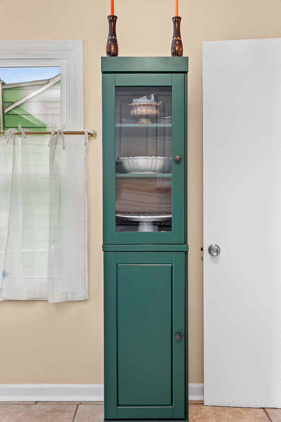 Pantry with serveware and storage for dry groceries. 