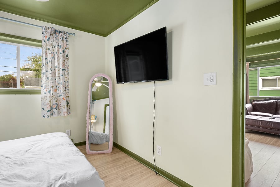 Large TV in bedroom. **An electric fireplace will be installed under the TV soon!!**