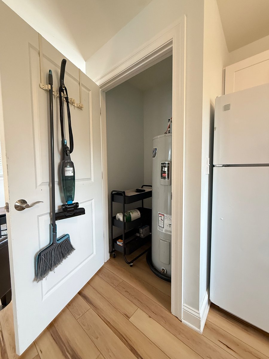 Utility closet adjacent to refrigerator