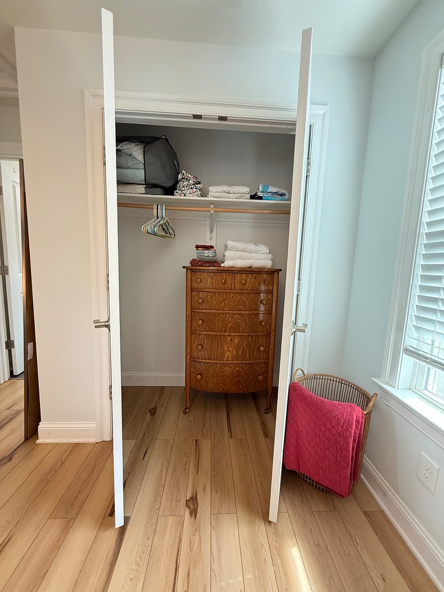 Queen BR closet interior with linens & dresser