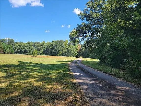 Beautiful private driveway leading to secluded home at the back of 17 acres.