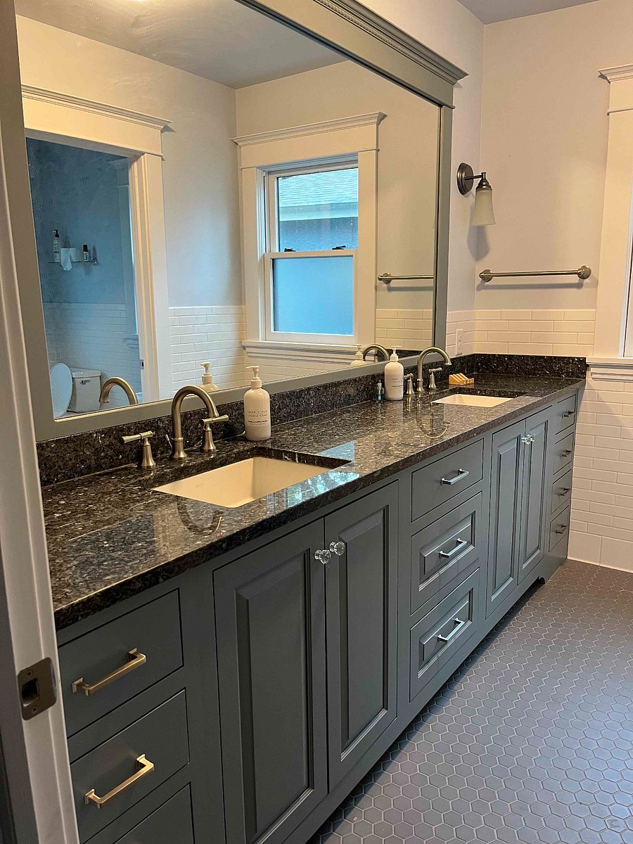 Double vanity in second floor bathroom. There is a door between the vanities and the toilet room.