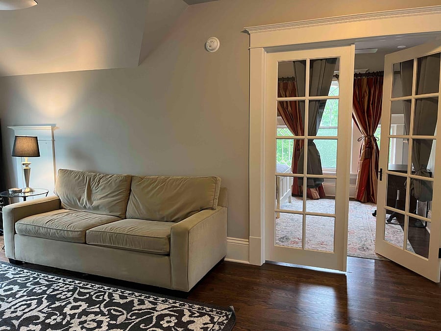 Sitting room with queen pull-out sofa. The French doors of the attic bedroom are shown.