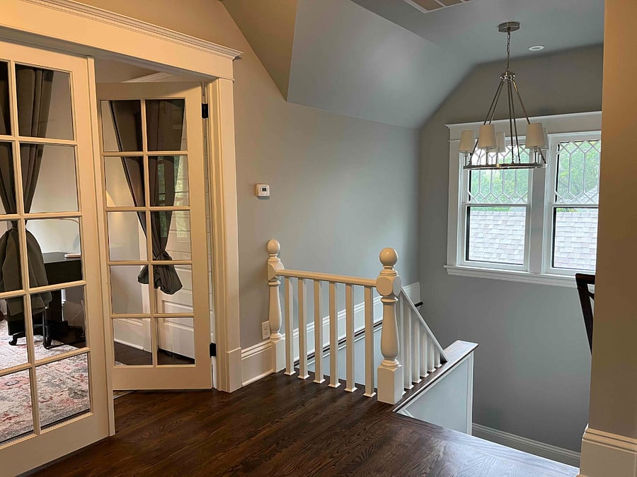 Stairwell leading to attic (third floor) and French doors of the attic bedroom.