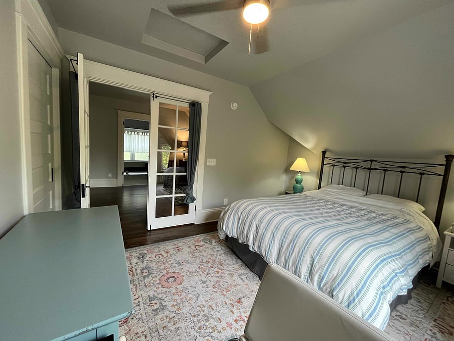 Attic bedroom (queen bed) with view of sitting room and bathroom.