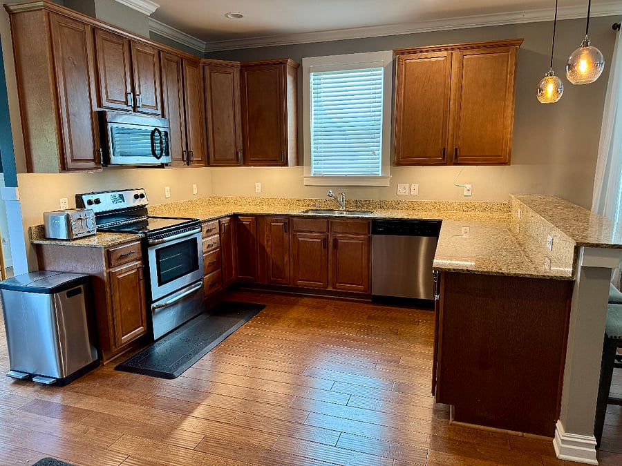 Kitchen area includes microwave, electric range and full sized oven. Side by side refrigerator with water dispenser and ice maker. Dishwasher. Garbage disposal.