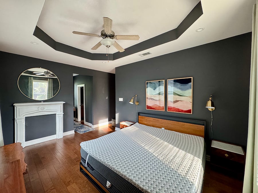 Master bedroom. Night stands on each side of king mattress. Bedside lamps dimmable. Ceiling fan. 
