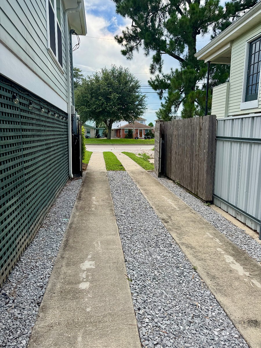Driveway leading into back yard. Gate closes to secure backyard. Can fit 2 vehicles behind gate. 