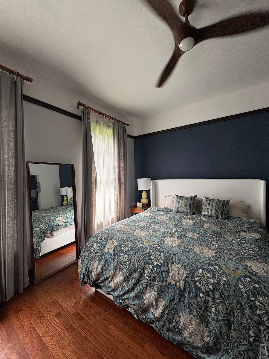 Bedroom with king sized bed, dresser and spacious closet