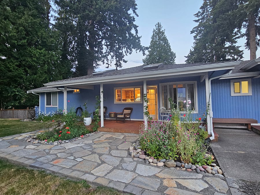 Front porch surrounded by cottage garden.
