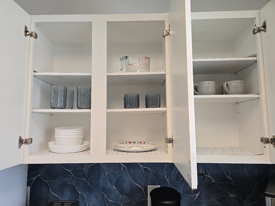 Kitchen is supplied with pot and pans, dishes and basic cooking/baking items