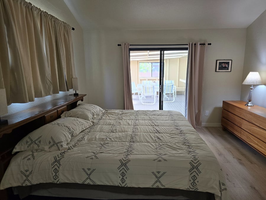Master bedroom with sliding glass door to enclosed patio