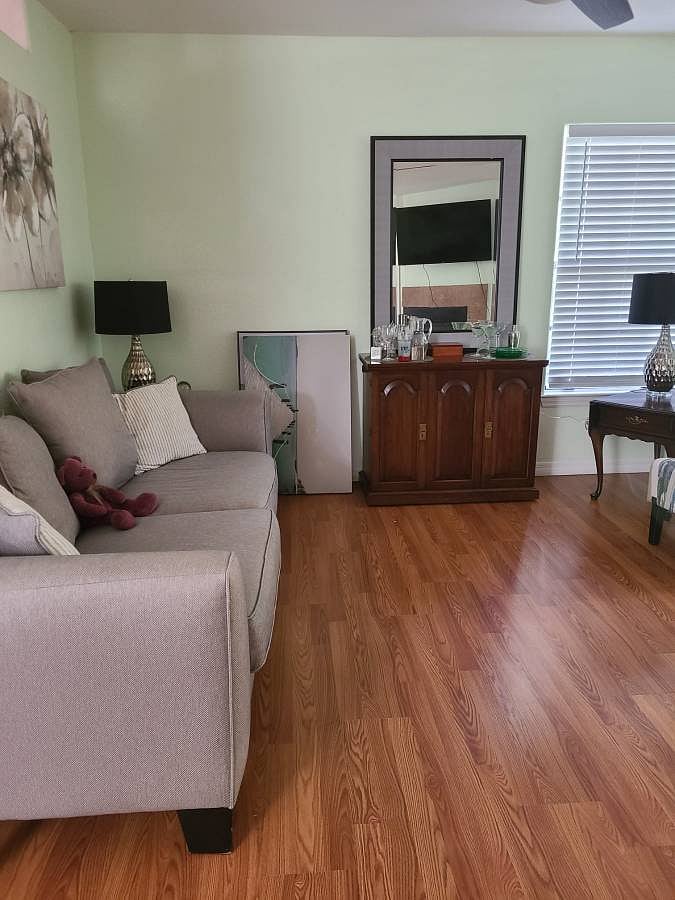 Shared living room has a fireplace and large flat screen TV for use.