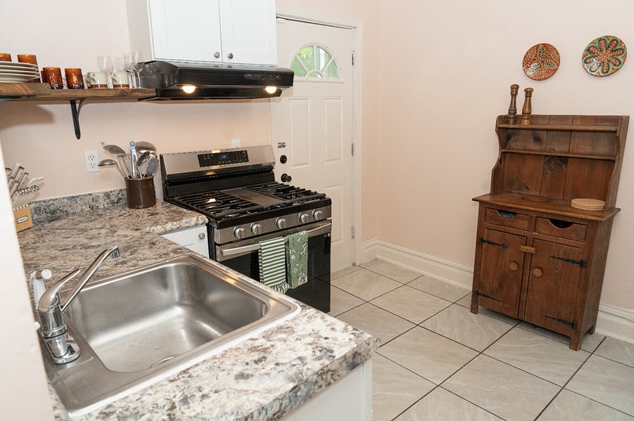 The hutch houses utensils, food storage containers, baking dishes, etc. 