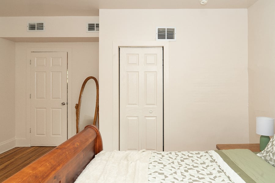 A full sized mirror and a closet in the primary bedroom. 