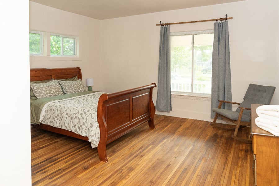 The primary bedroom is large and features a brand new queen size bed and black out curtains. 