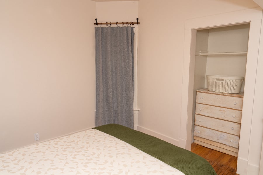 A dresser and closet are available for clothing storage. 