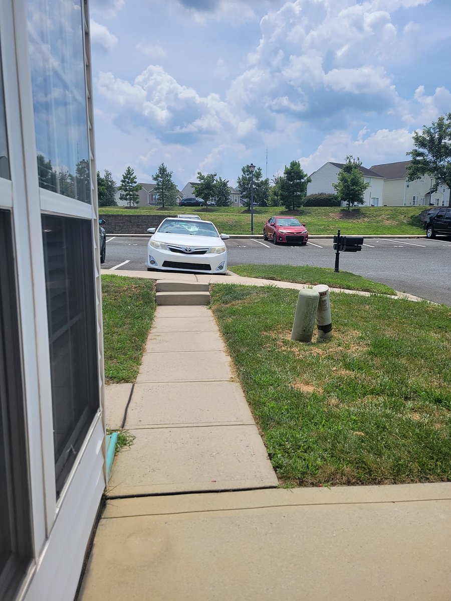 Sidewalk to parking space (where white Camry is). The other parking space is across the drive.