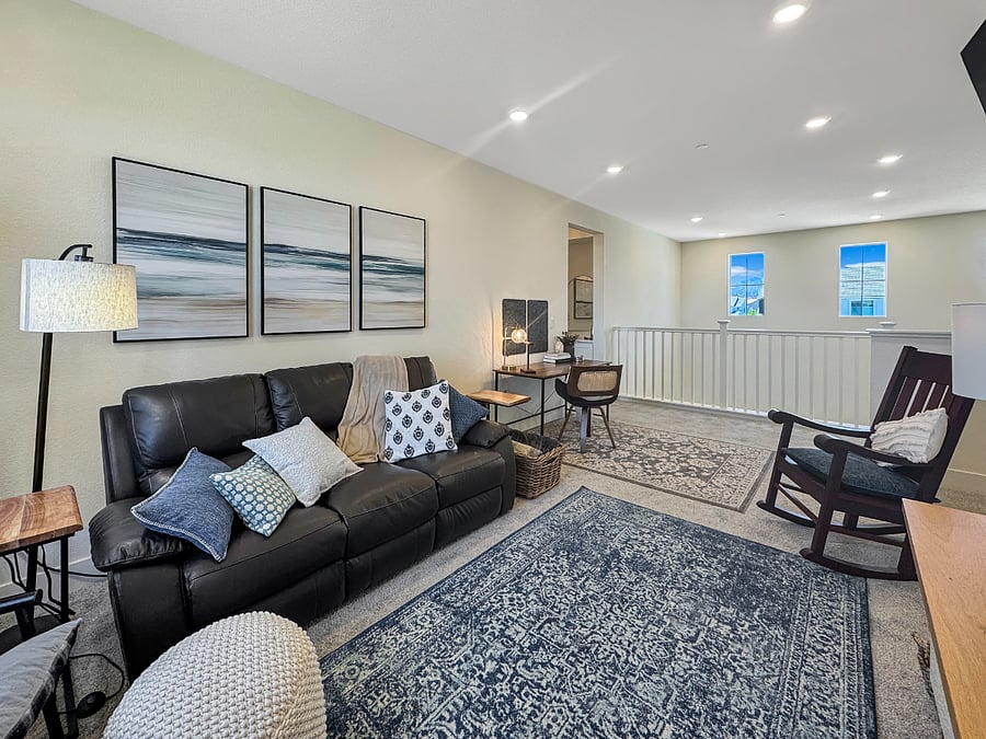 Cozy loft with smart tv, leather recliner, custom rocking chair, comfy side chairs, and task table and chair. Featuring a great view of the park!