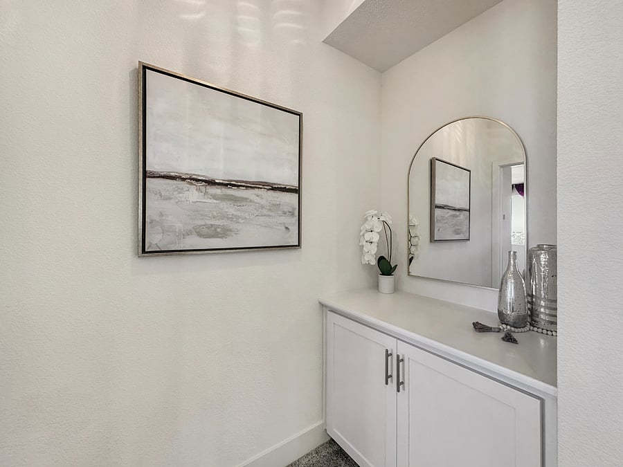 Nook entrance to master bedroom with accent lighting and decorative mirror.