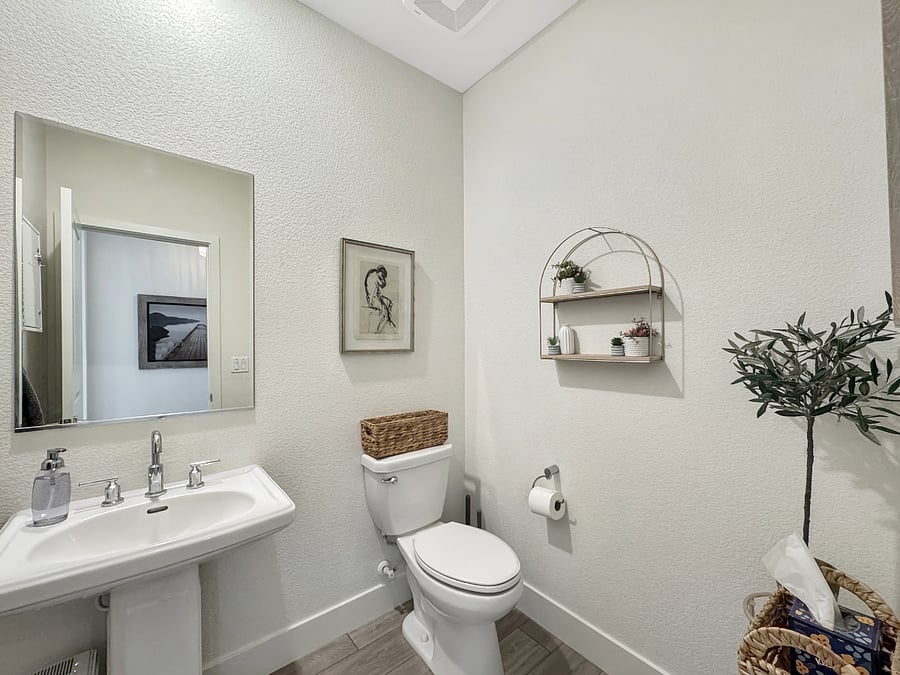 Downstairs half-bath next to the garage entrance and the grand entrance.