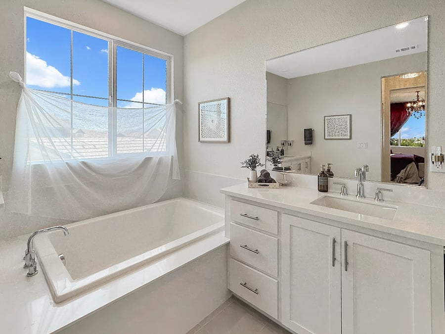 Huge master suite bathroom featuring large soaking tub and his and her sinks.