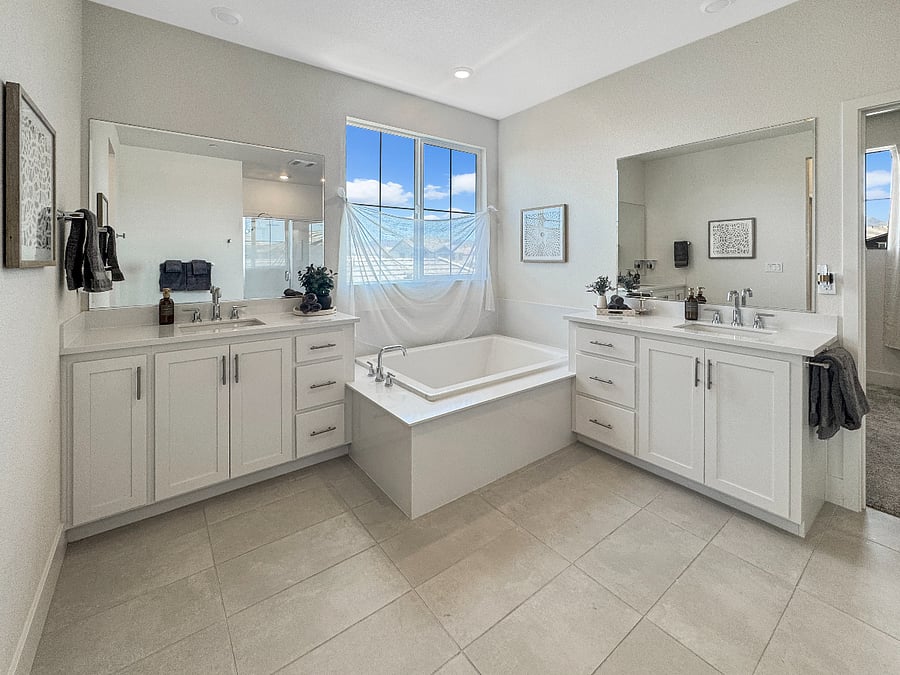 Huge master suite bathroom featuring large soaking tub and his and her sinks.