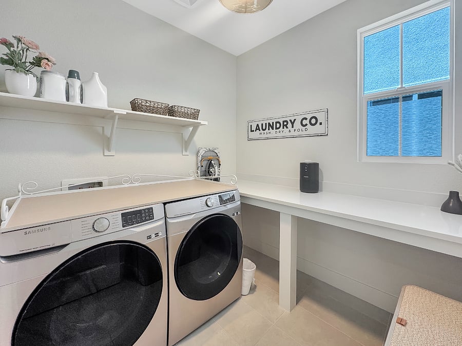 Extra large laundry room featuring modern Samsung washer and dryer with plenty of room for folding clothes.