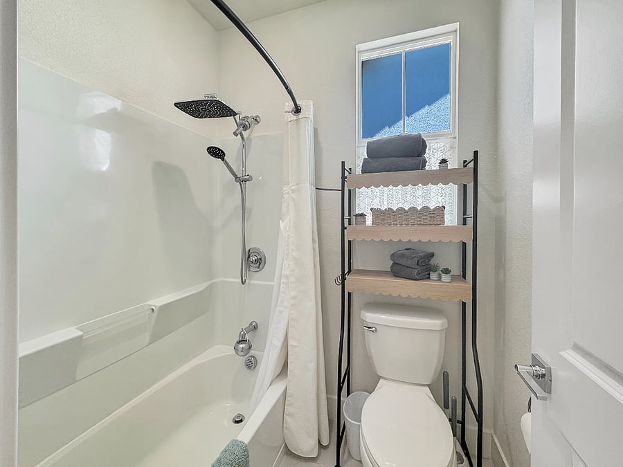 Full bathroom supporting Gold, Green, and Blue rooms. Feature's a large mirror, dual sinks, extended shower curtain, and upgraded rain shower head with filtered water.