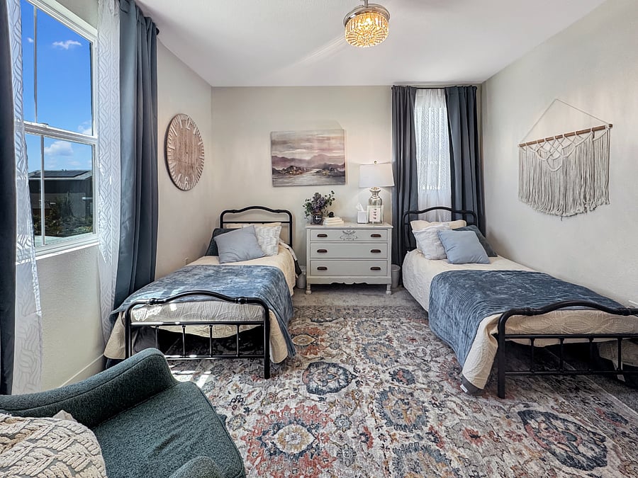 "Blue Room" sleeps two in twin beds. Features a comfy sofa chair and gorgeous chandelier ceiling fan.